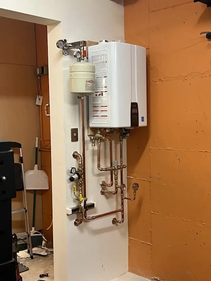 Plumbing technician inspecting water heater connections in Belterra